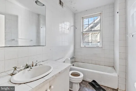 a bathroom with a sink bathtub and a toilet