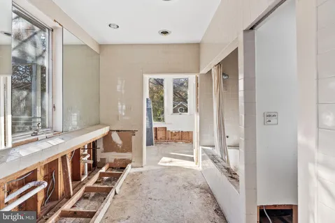 a view of a hallway with wooden floor and windows