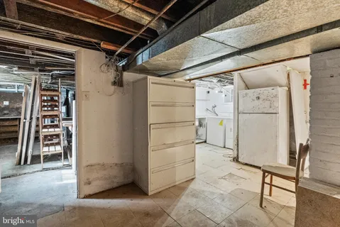 a utility room with cabinets and washer