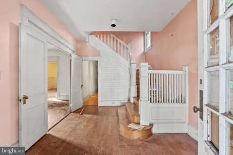 a view of an entryway with wooden floor