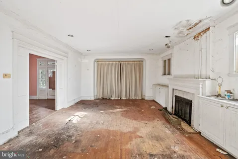 a view of a kitchen with a sink dishwasher and a fireplace