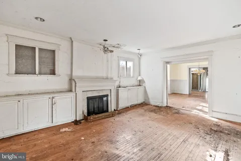 a view of a kitchen with a sink dishwasher and a fireplace