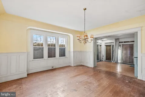 a view of an empty room with chandelier