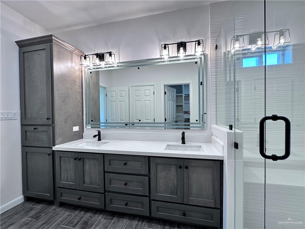 1100 Azalea Street Mission, TX 78573 - Photo 16 of 24 a bathroom with a double vanity sink mirror and double