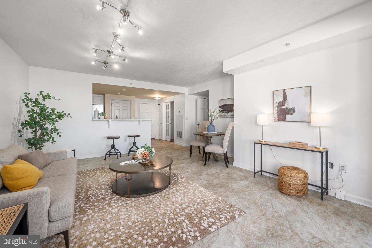 2726 Gallows Road, Unit 1004 Vienna, VA 22180 - Photo 3 of 17 a living room with furniture and a chandelier