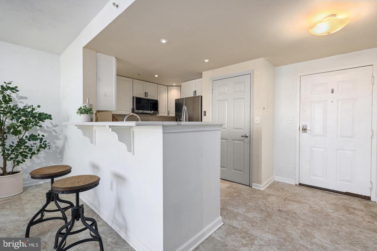 2726 Gallows Road, Unit 1004 Vienna, VA 22180 - Photo 7 of 17 a kitchen with stainless steel appliances a refrigerator and a stove top oven