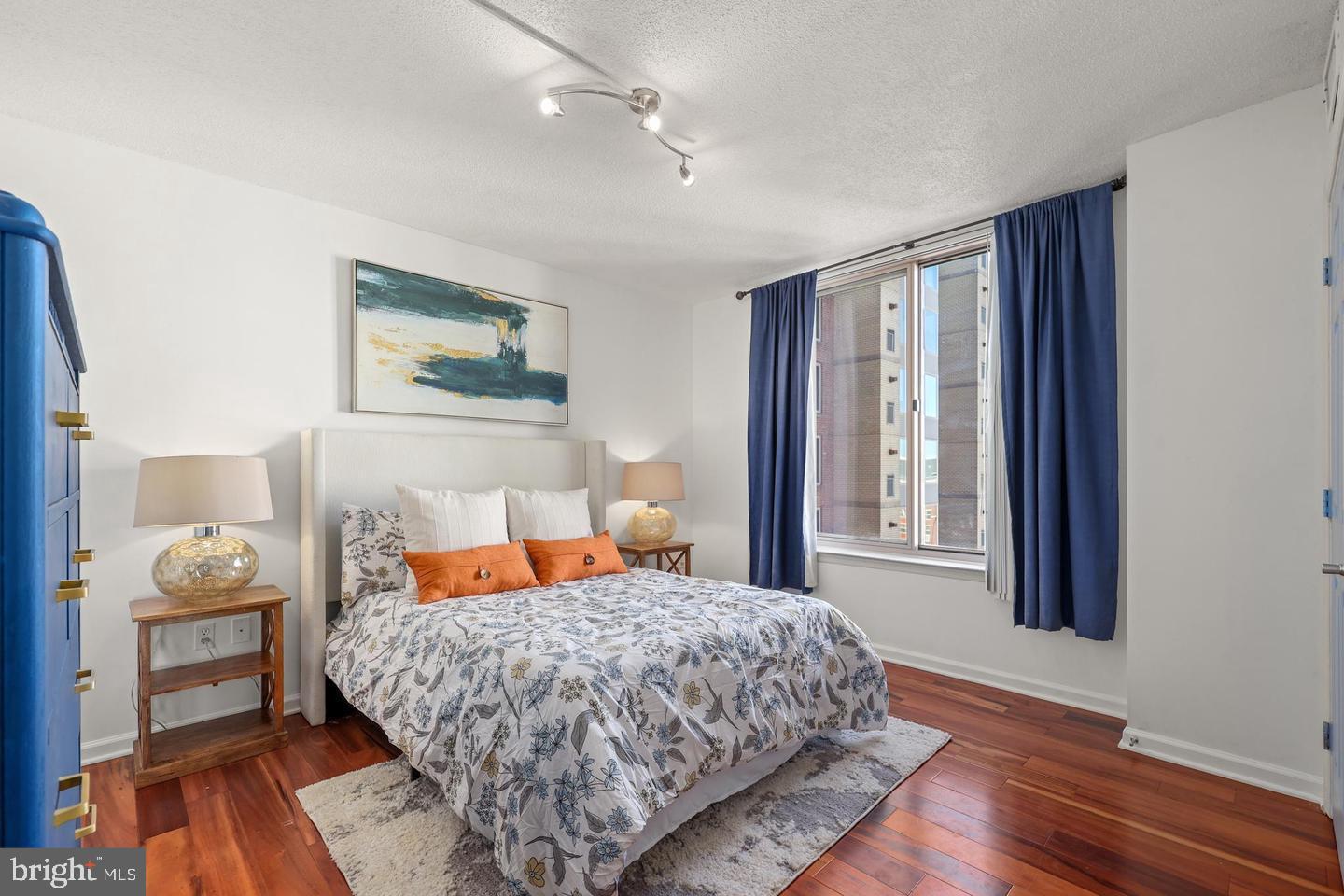 2726 Gallows Road, Unit 1004 Vienna, VA 22180 - Photo 9 of 17 a bedroom with a bed and wooden floor