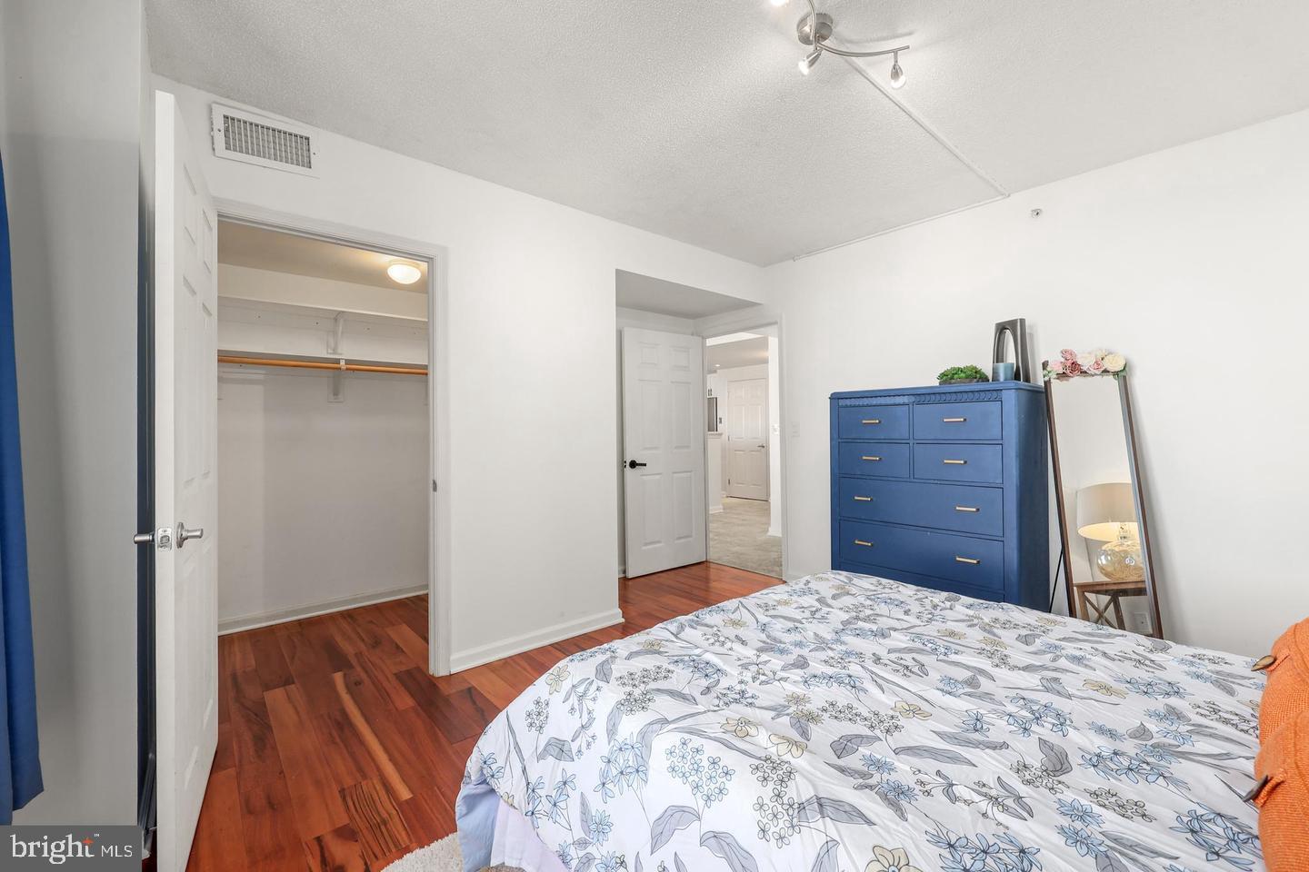 2726 Gallows Road, Unit 1004 Vienna, VA 22180 - Photo 10 of 17 a bedroom with a bed and a dresser