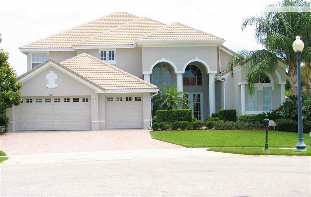 9069 Dancy Tree Court Orlando, FL 32836 - Photo 1 of 1 a view of a white house with a yard and potted plants
