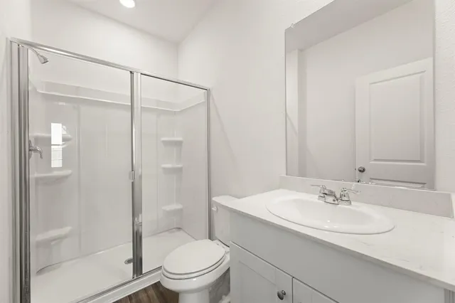 a bathroom with a sink toilet and shower