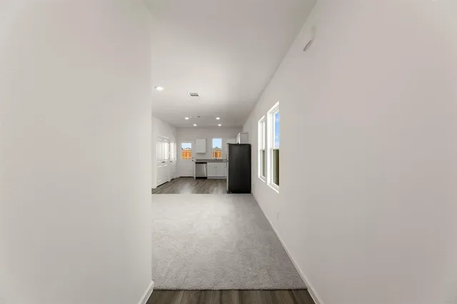 a view of a hallway with a kitchen