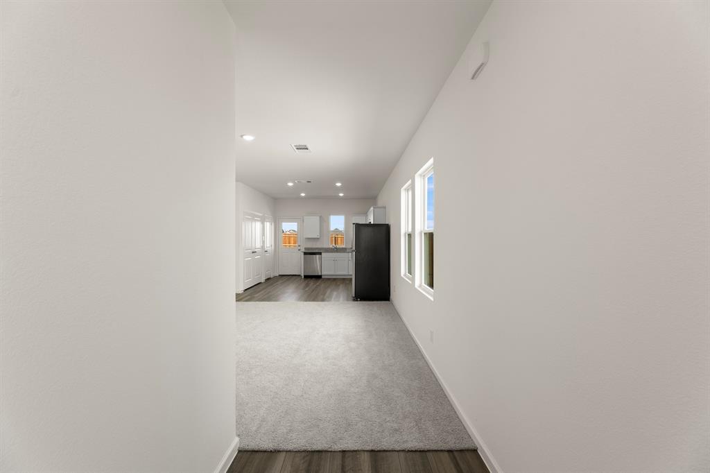 501 Merced River Lane Anna, TX 75409 - Photo 5 of 28 a view of a hallway with a kitchen