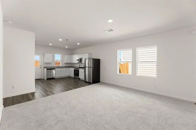 a view of a kitchen with a sink stove and a window