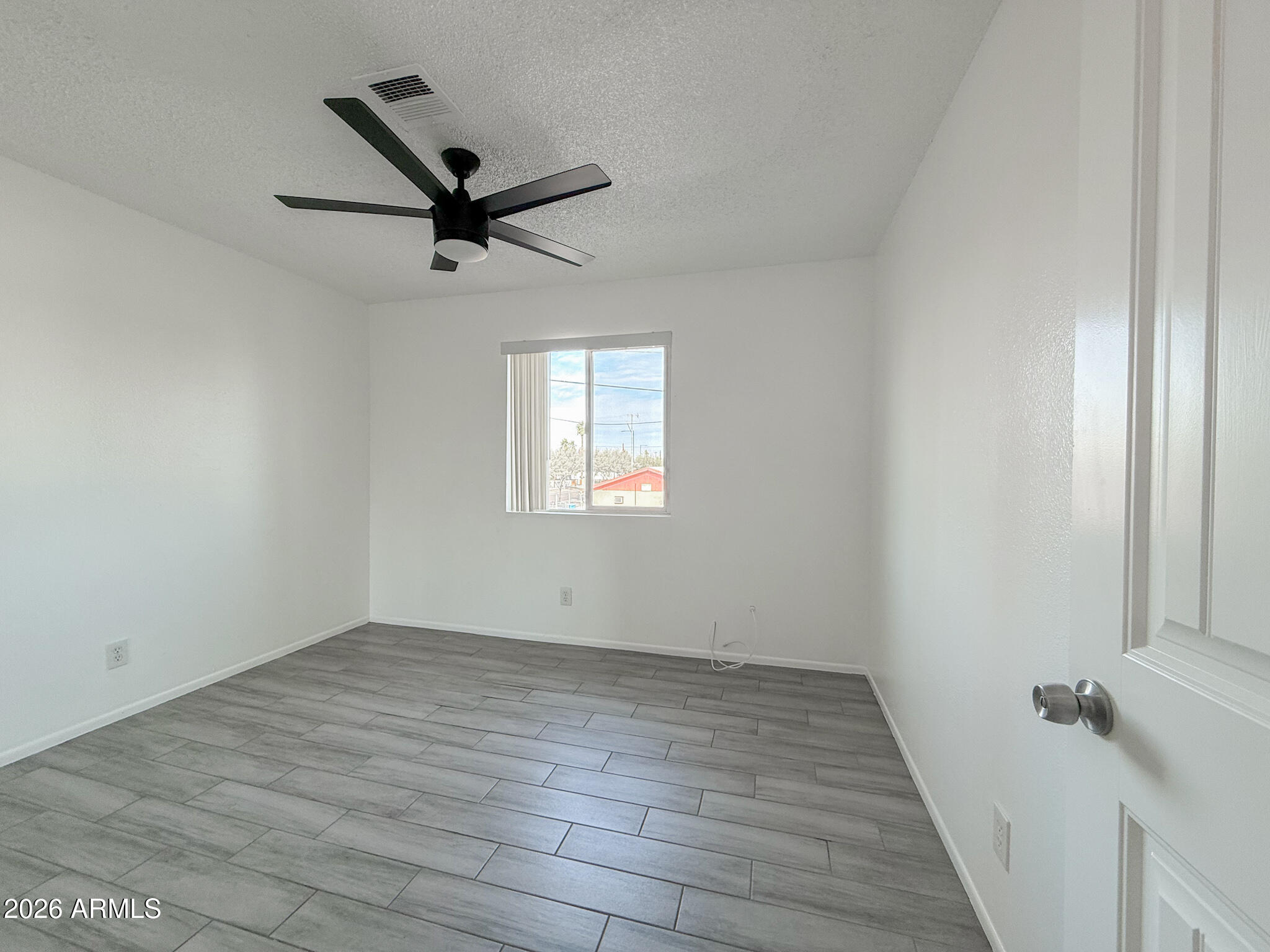 349 North 11th Street, Unit 207 Phoenix, AZ 85006 - Photo 13 of 20 wooden floor in an empty room with a window