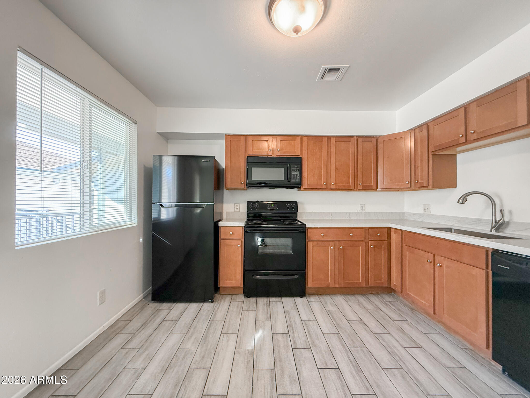 349 North 11th Street, Unit 207 Phoenix, AZ 85006 - Photo 6 of 20 a kitchen with granite countertop wooden floors a stove and a refrigerator