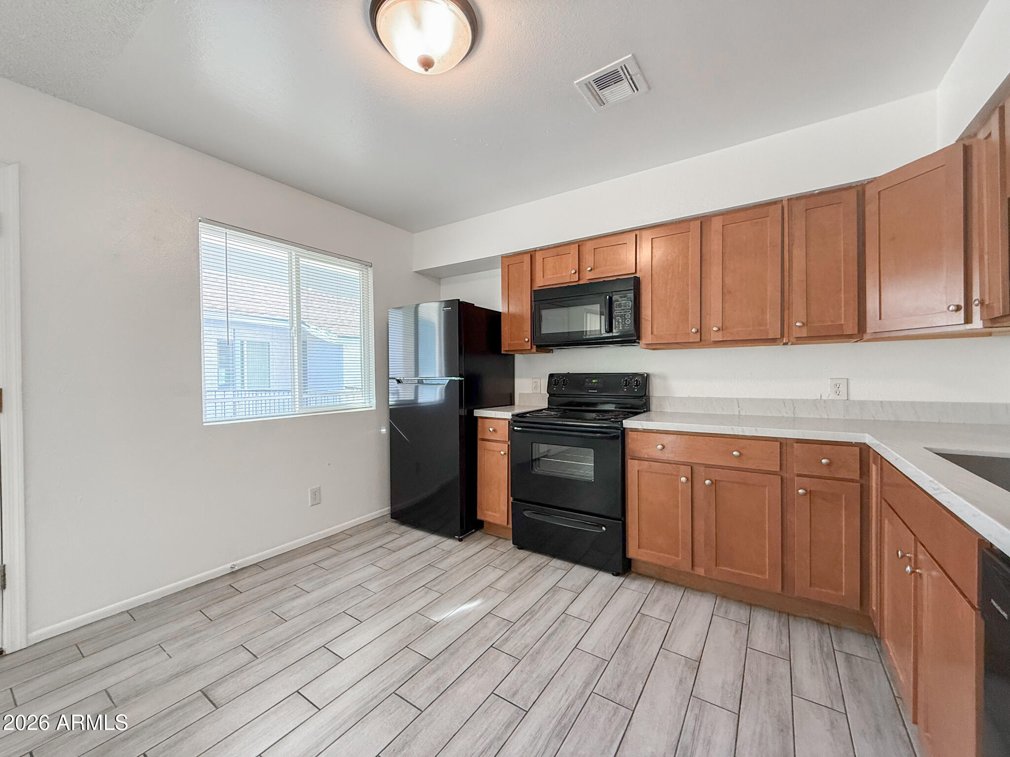 349 North 11th Street, Unit 207 Phoenix, AZ 85006 - Photo 8 of 20 a kitchen with granite countertop a refrigerator stove top oven and sink