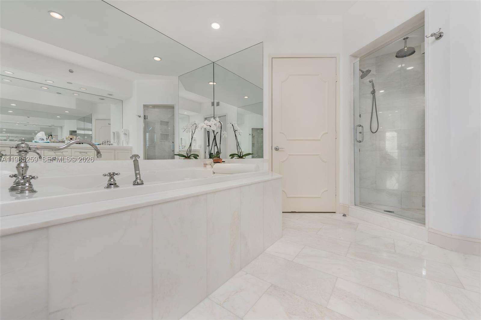 781 Crandon Boulevard, Unit 1603 Key Biscayne, FL 33149 - Photo 13 of 34 a bathroom with a double vanity sink mirror and shower