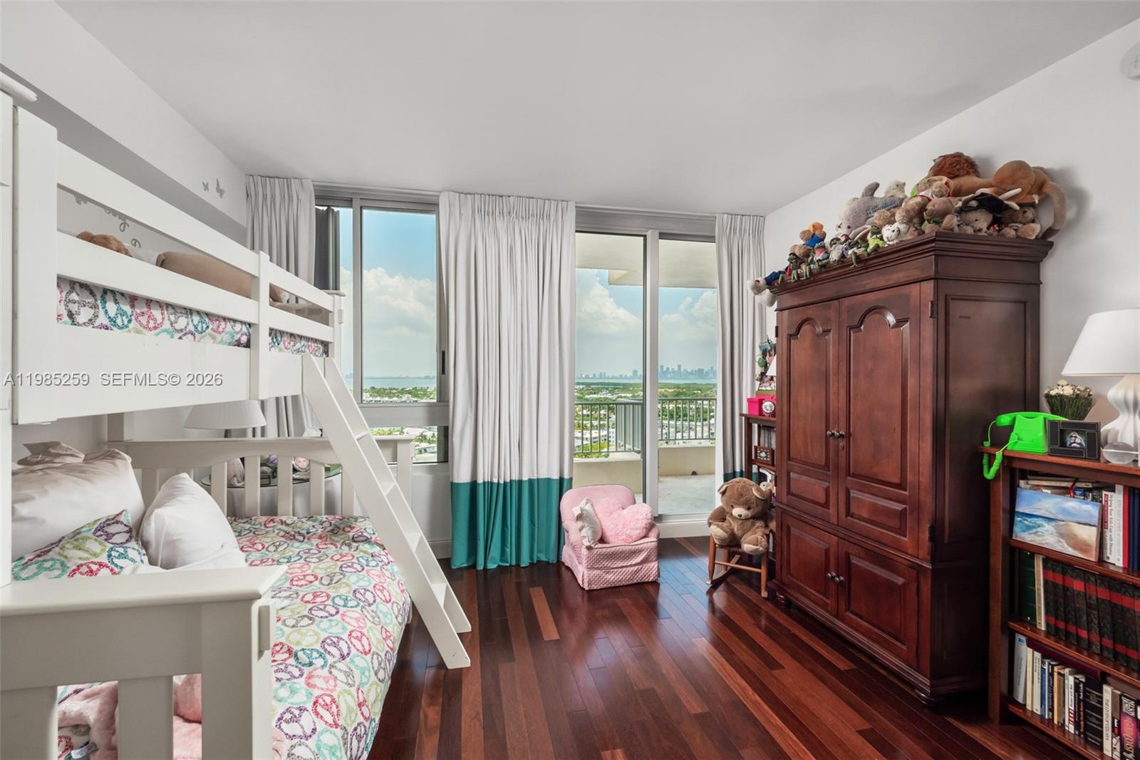781 Crandon Boulevard, Unit 1603 Key Biscayne, FL 33149 - Photo 17 of 34 a view of a livingroom with lounge chair and a large window