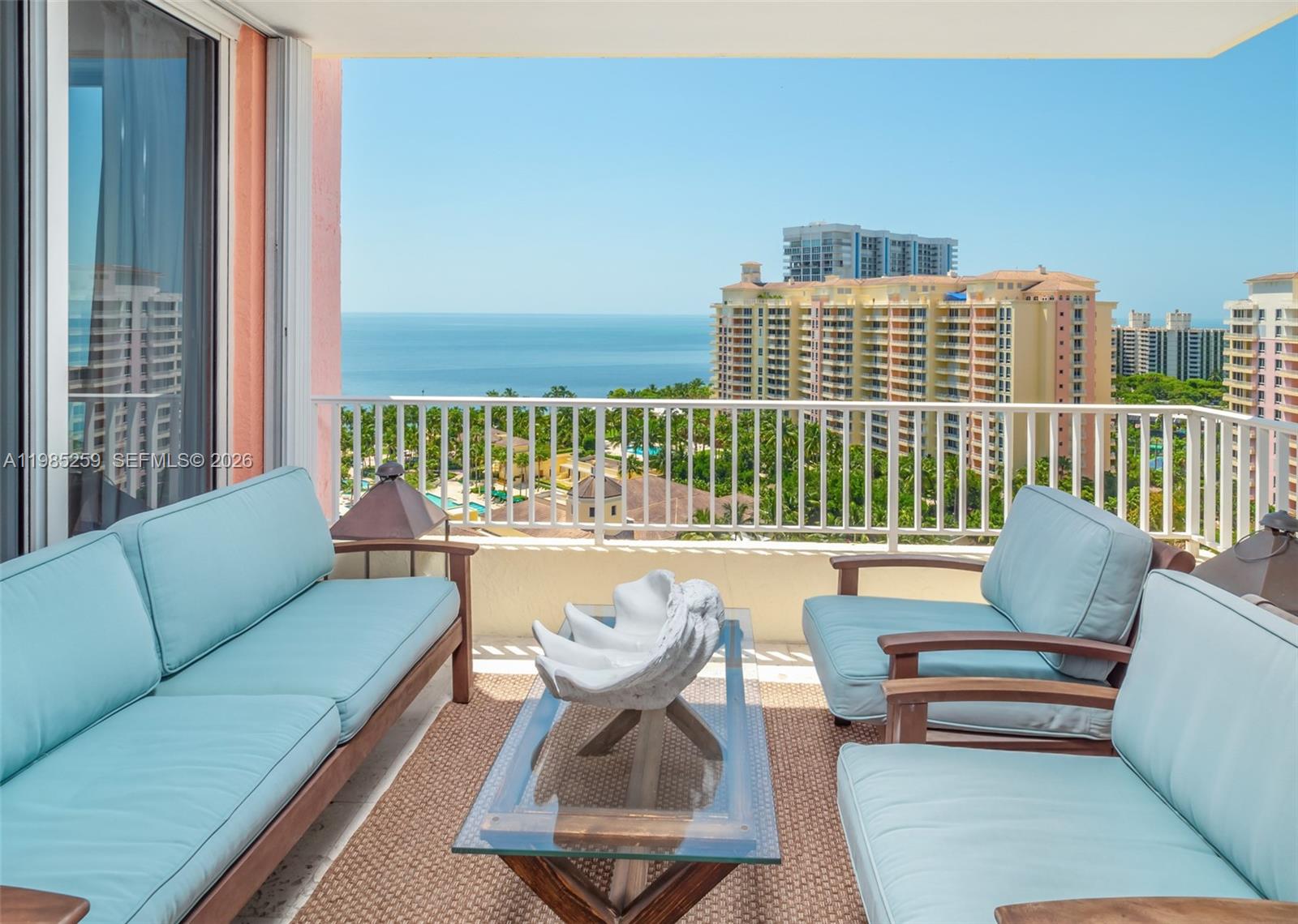 781 Crandon Boulevard, Unit 1603 Key Biscayne, FL 33149 - Photo 19 of 34 a living room with furniture and a floor to ceiling window