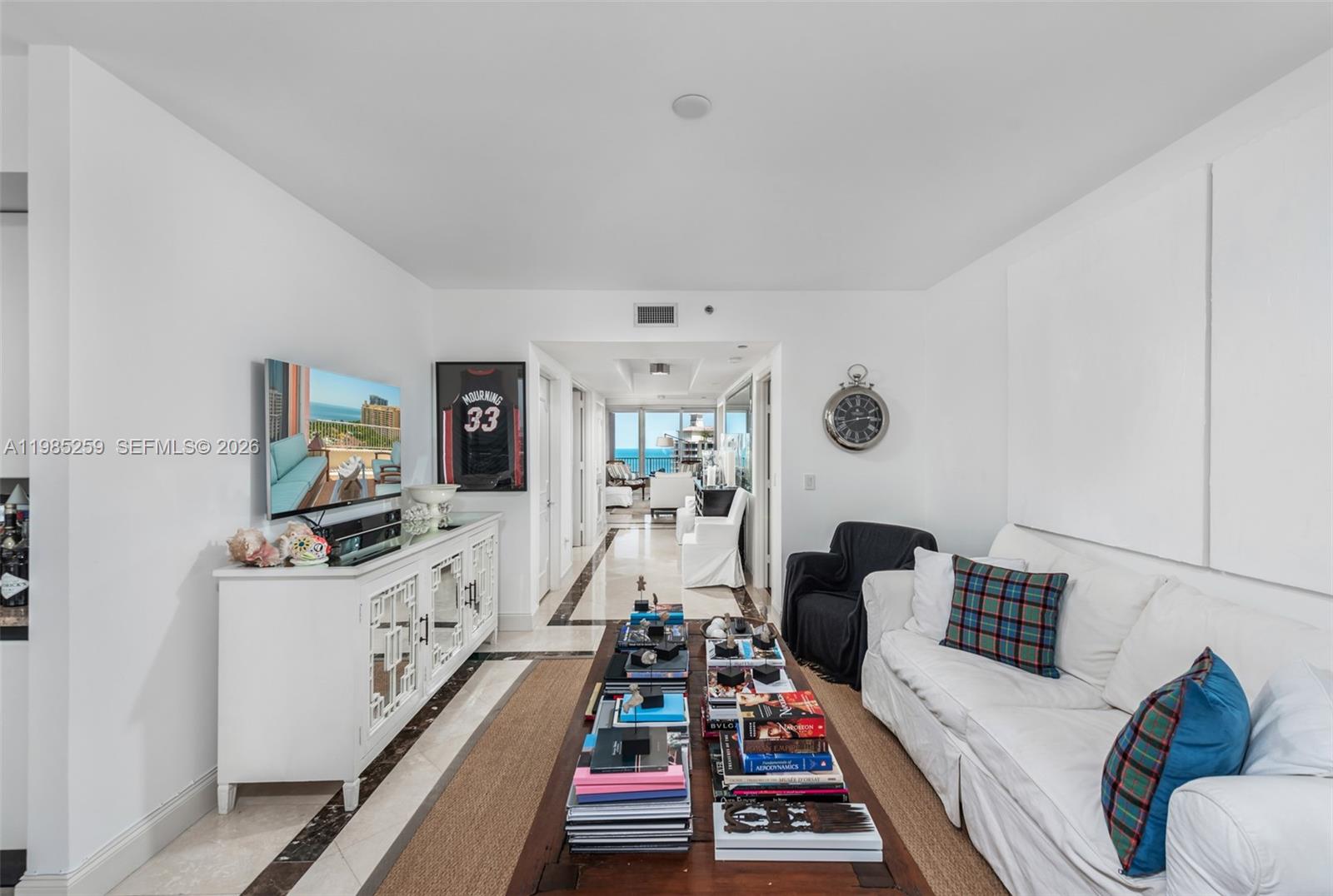 781 Crandon Boulevard, Unit 1603 Key Biscayne, FL 33149 - Photo 6 of 34 a room with furniture a rug and a flat screen tv