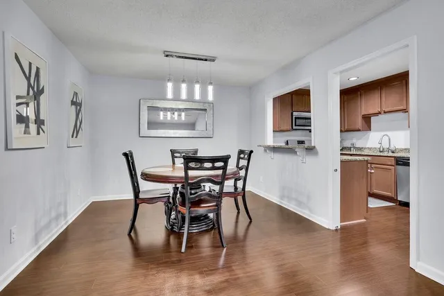 a view of a dining room with furniture and wooden floor