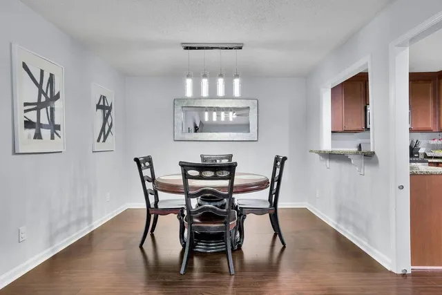 a view of a dining room with furniture and wooden floor