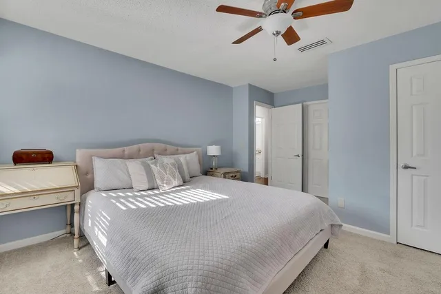 a bedroom with a large bed and a flat screen tv