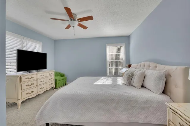 a bathroom with a granite countertop sink and white cabinets