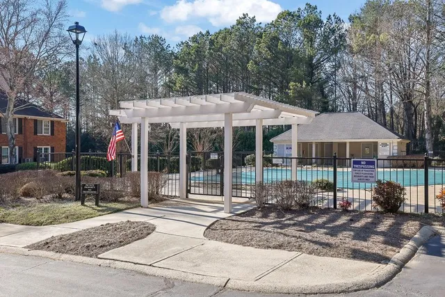 a view of a house with a yard and large tree