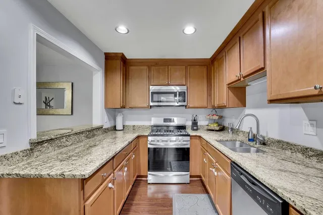 a kitchen with granite countertop a sink and cabinets