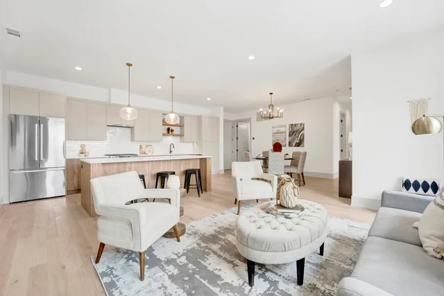 a living room with furniture and kitchen view