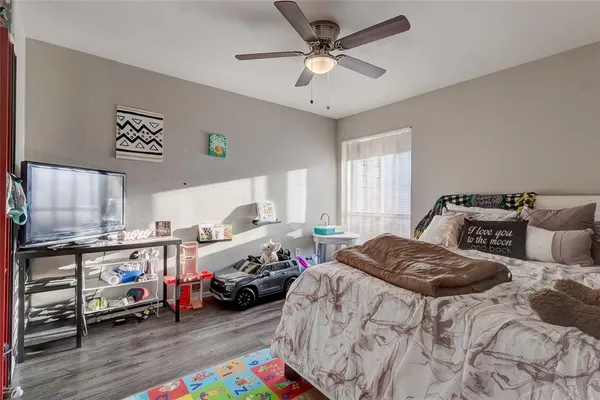 a bedroom with bed and a window