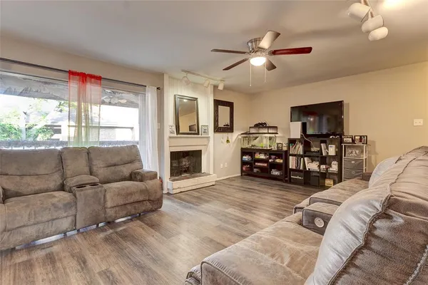 a living room with furniture window and a flat screen tv