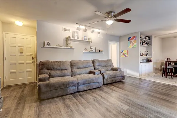 a living room with furniture and kitchen view