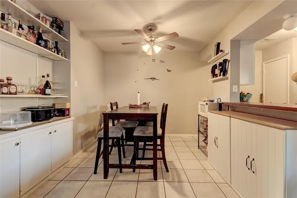 a kitchen with stainless steel appliances a table and chairs in it