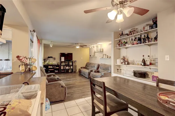 a living room with furniture and chandelier