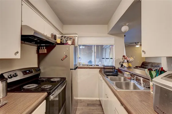 a kitchen that has a sink and a stove