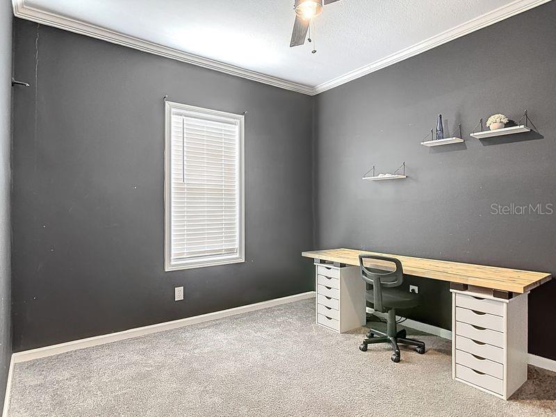 102 Ash Street Edgewater, FL 32141 - Photo 26 of 36 a room with a chair and white walls