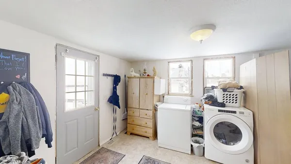 a view of a bedroom with washer and dryer