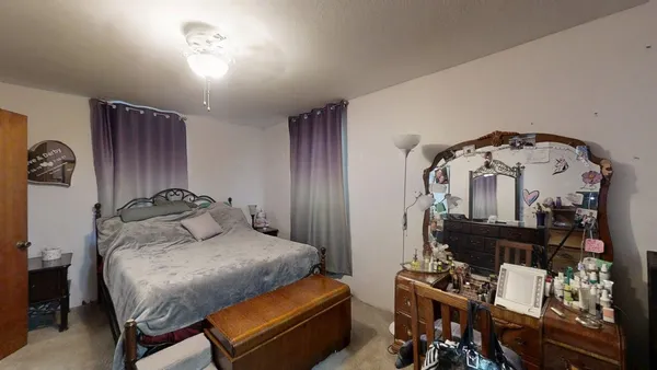 a bedroom with a bed and a mirror