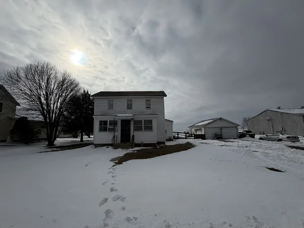a view of a house with a snow in front of house