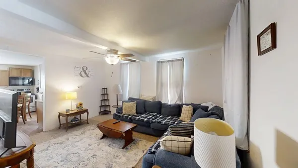 a living room with furniture and a lamp