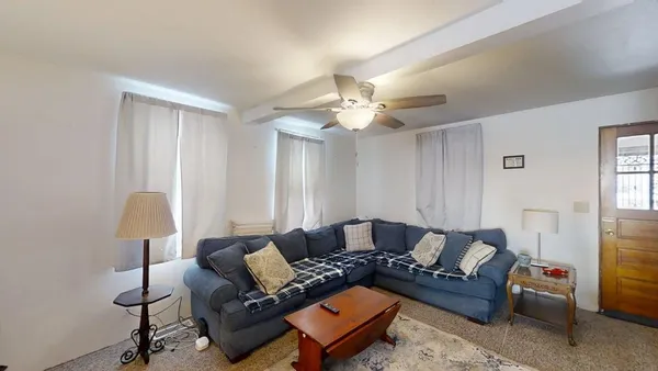 a living room with furniture and a lamp