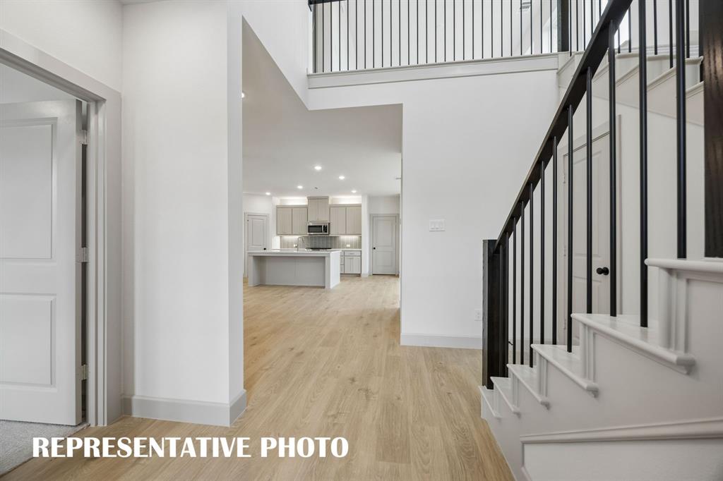 3775 Goddard Road McKinney, TX 75071 - Photo 3 of 20 Welcome into your beautiful new dream home featuring light wood-look flooring, elegant stair railings and open sight lines throughout! REPRESENTATIVE PHOTO