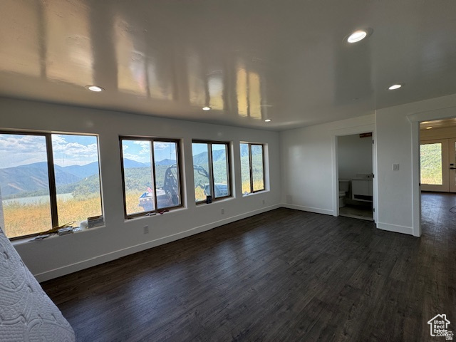 6909 East Spring Drive, Unit 19 Springville, UT 84663 - Photo 41 of 118 Expansive room featuring dark wood-finish flooring, recessed lighting, and white walls