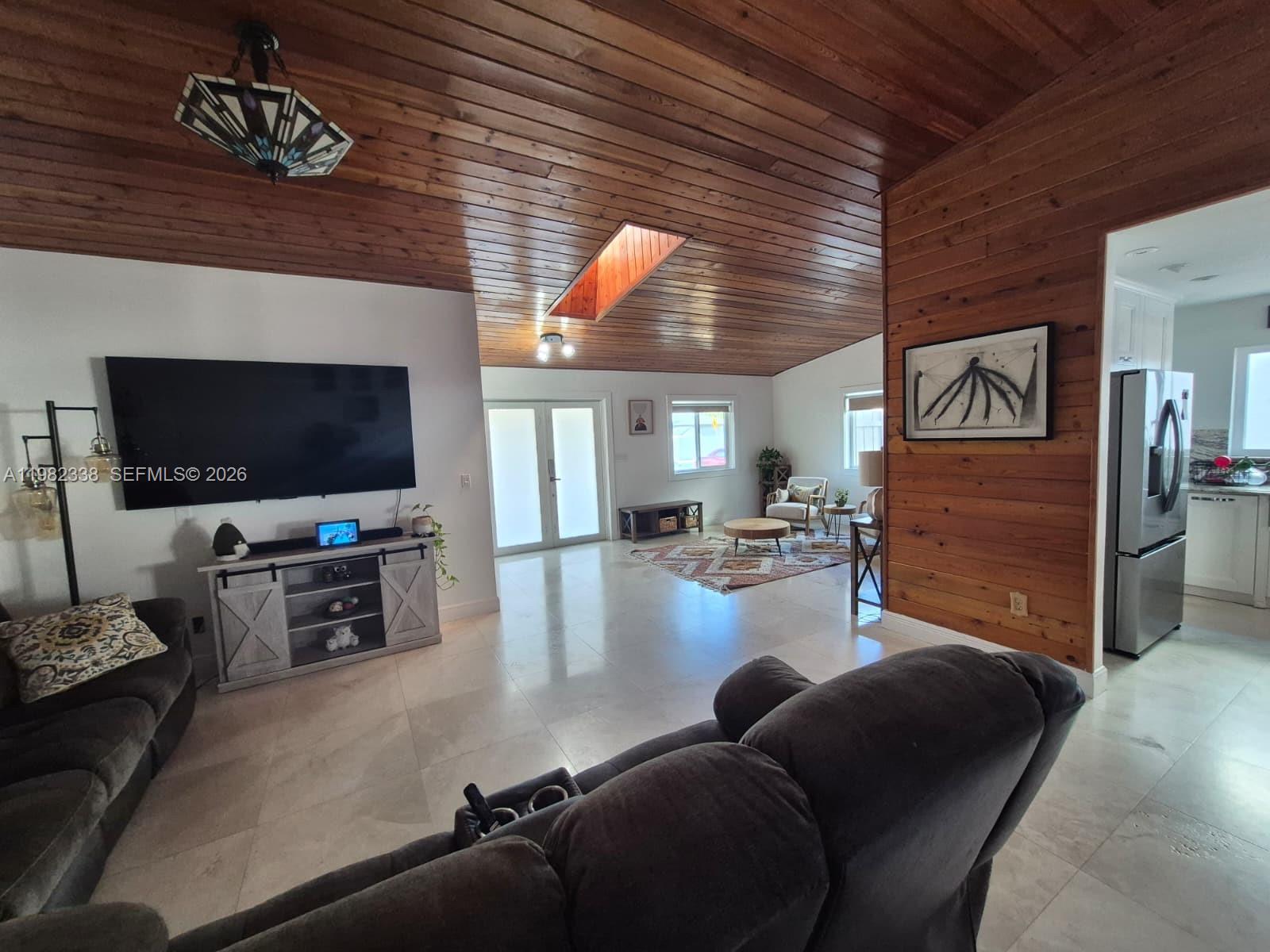 14530 Southwest 110th Street Miami, FL 33186 - Photo 8 of 45 a living room with furniture and a flat screen tv
