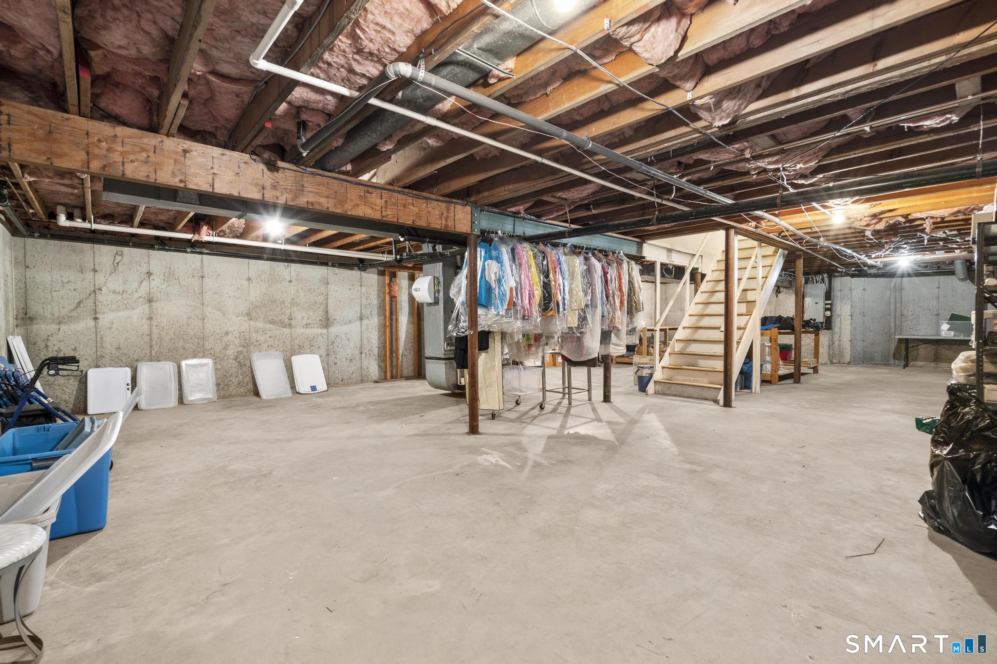 130 Stillson Road, Unit 130 Fairfield, CT 06825 - Photo 31 of 38 Unfinished basement provides plenty of storage and potential for future finishing if needed