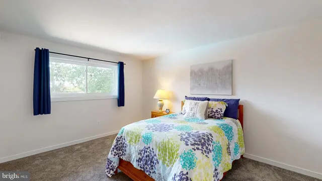 a bedroom with a bed and a lamp