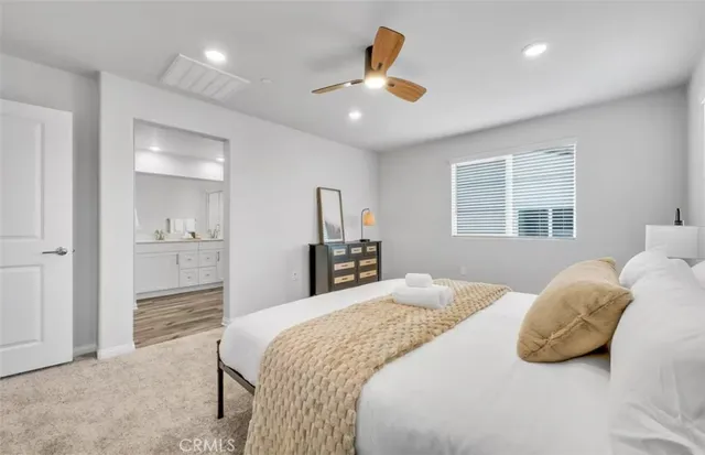 a bedroom with a large bed and a chandelier