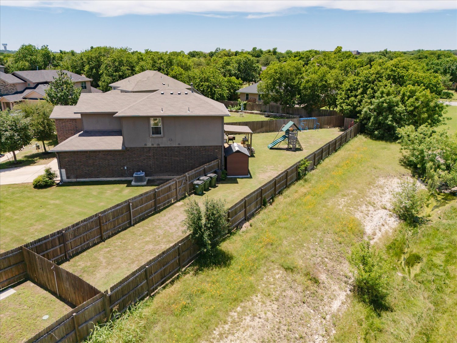 717 Kaluga Trail Leander, TX 78641 - Photo 34 of 40 an aerial view of a house with swimming pool and large trees